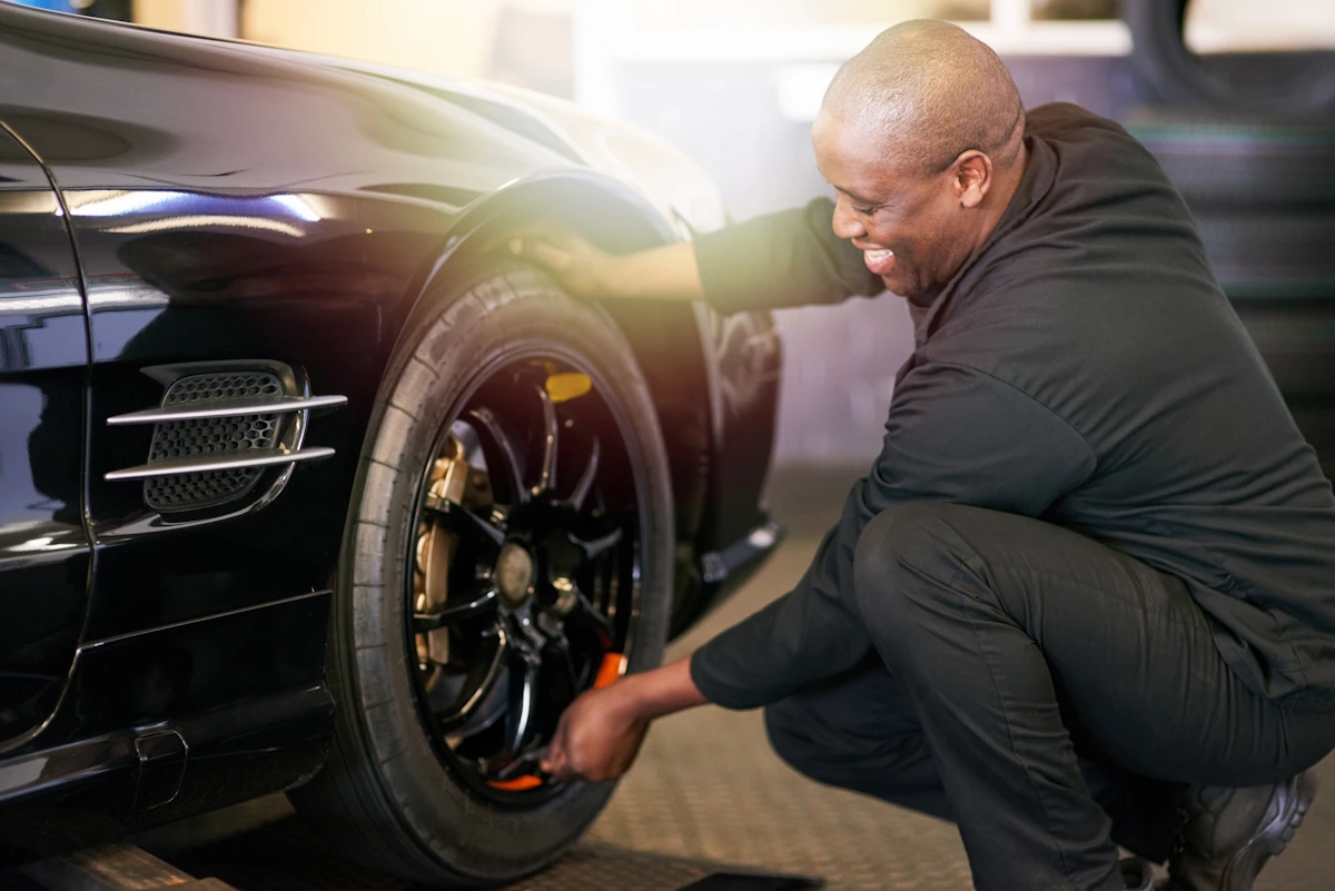 Un contrôleur technique qui regarde les pneus d'une voiture