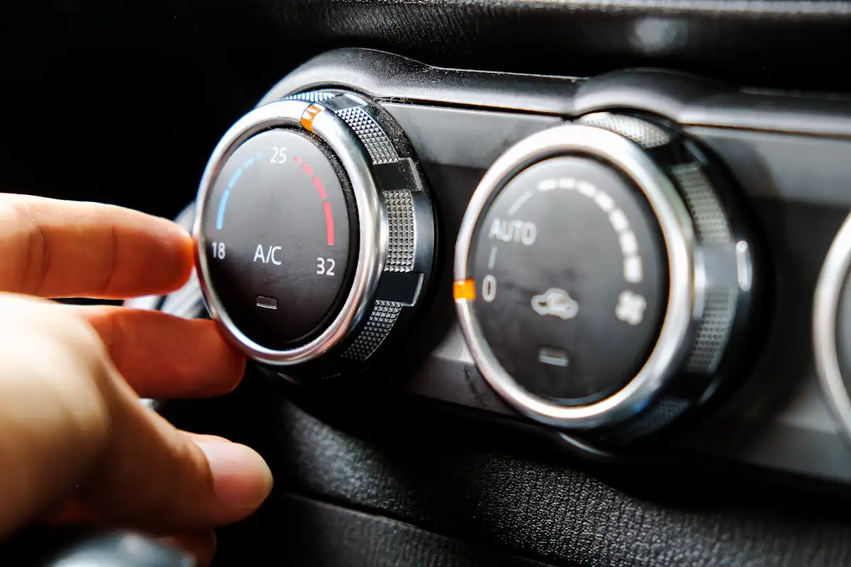 Une personne qui allume la climatisation voiture