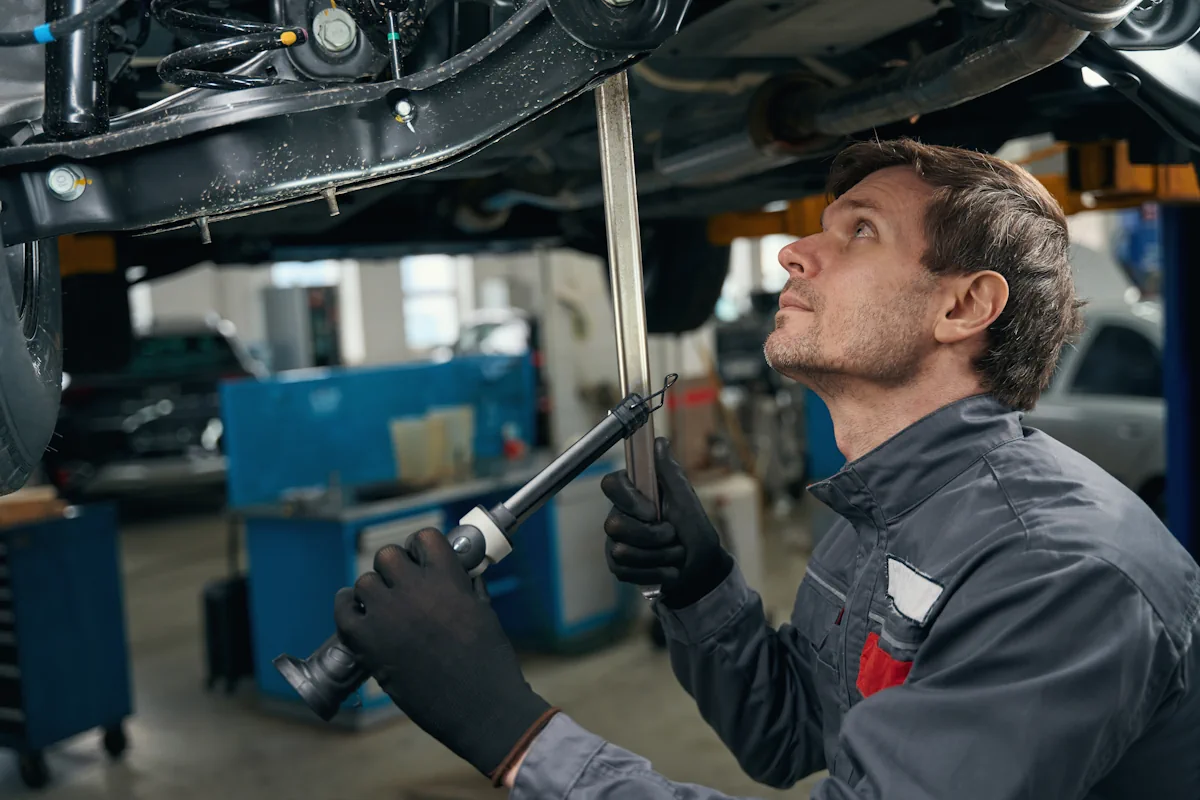 Un homme qui fait un contrôle technique de la barre de direction voiture
